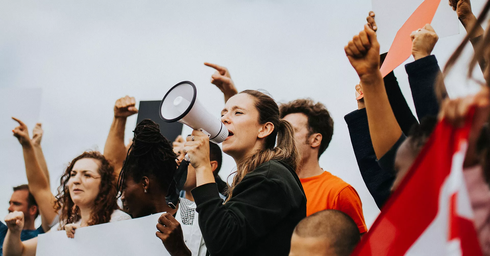 woman speaking into a microphone at a rally